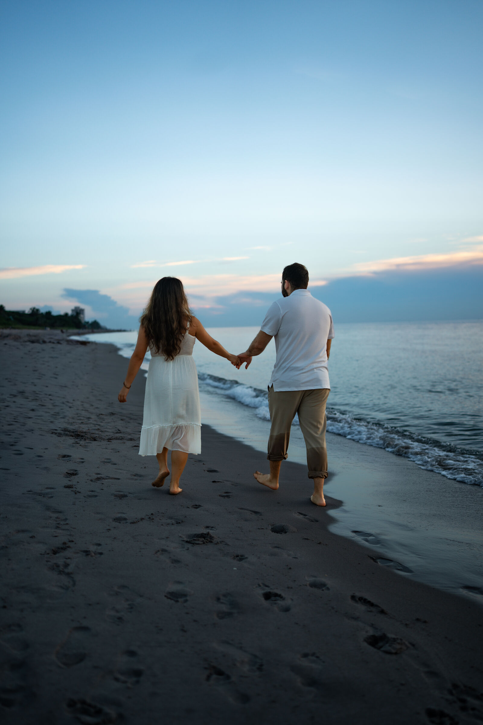 Couple walking the shoreline hand in hand